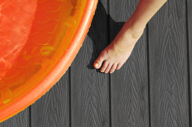 Mid-Grey Composite Dark Decking Swatch With Foot and Orange Paddling Pool
